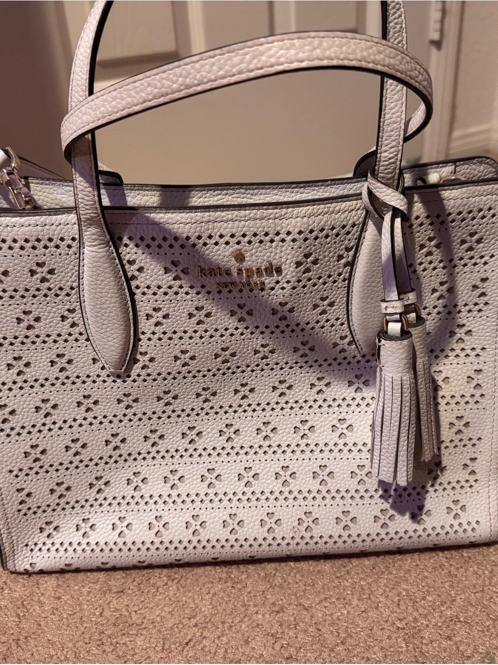 kate spade cream perforated leather tote with tassel